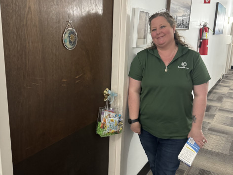 A SANEWA volunteer delivering May Day baskets inside a senior apartment community