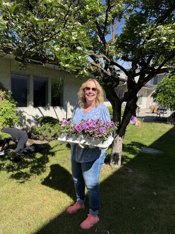 A SANEWA volunteer carrying flowers for the Wedgewood garden