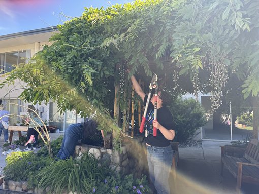 SANEWA volunteers refreshing an outdoor gathering space at Wedgewood Senior Living